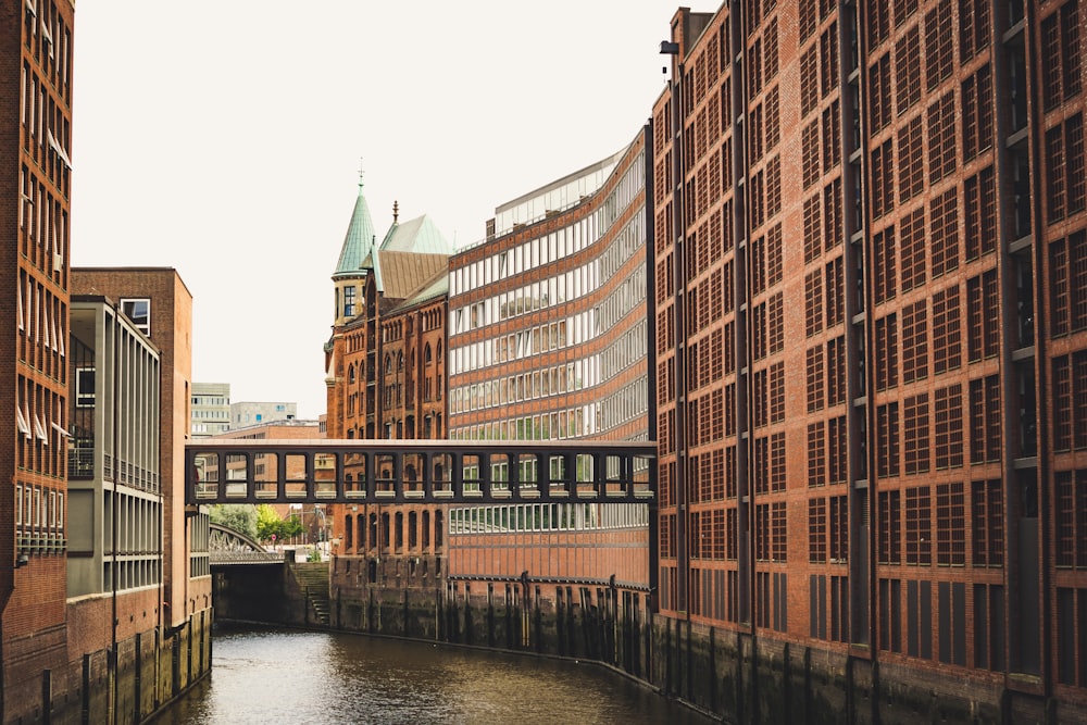 brown concrete building beside river during daytime