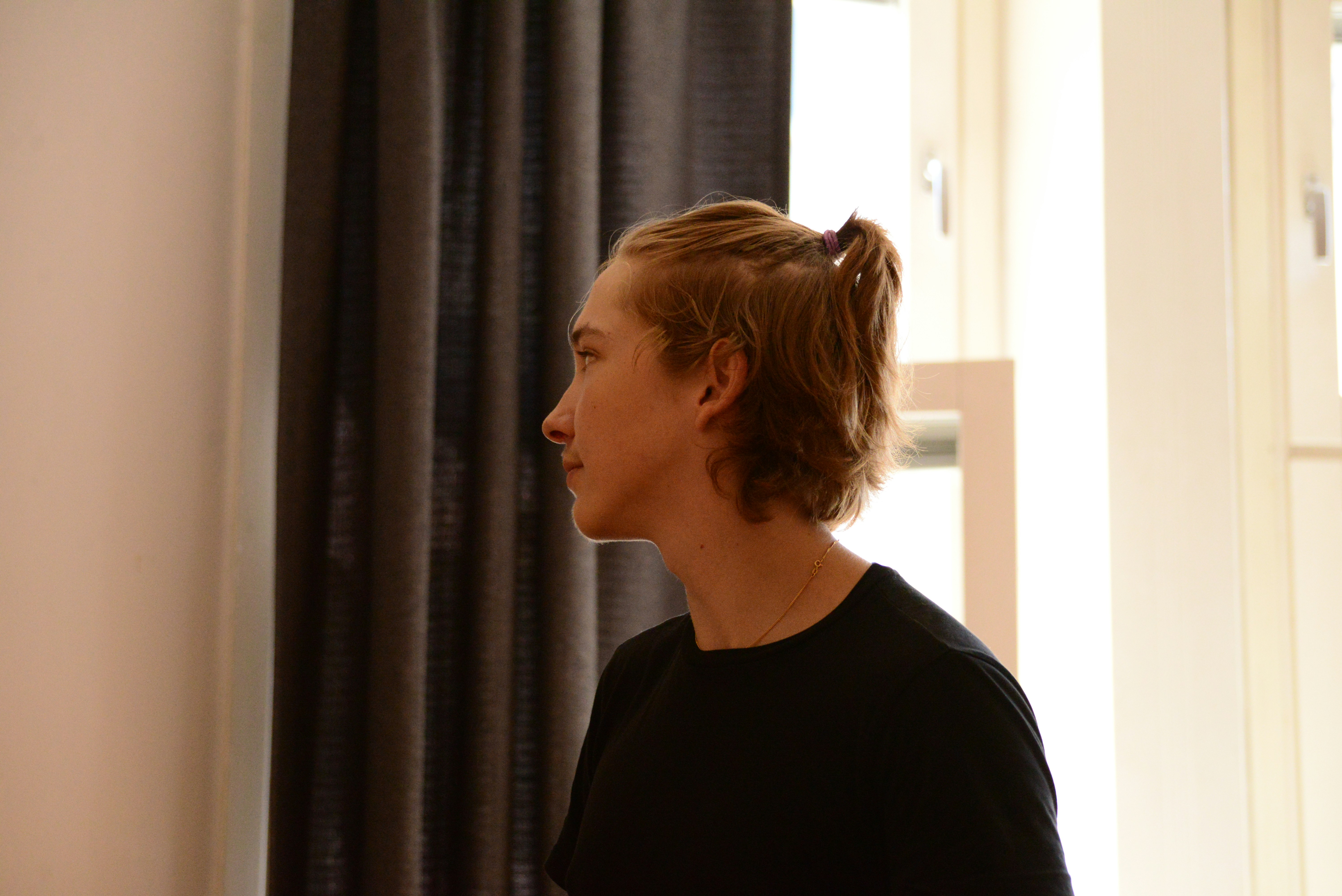 a woman standing in front of a window