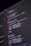 A close-up view of computer code displayed on a dark screen, featuring syntax highlighted in various colors such as red, blue, green, and yellow against a black background. The code appears to be JavaScript, containing functions, variables, and commands.