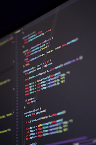 A close-up of a computer screen displaying complex algorithm code with colorful syntax highlighting.