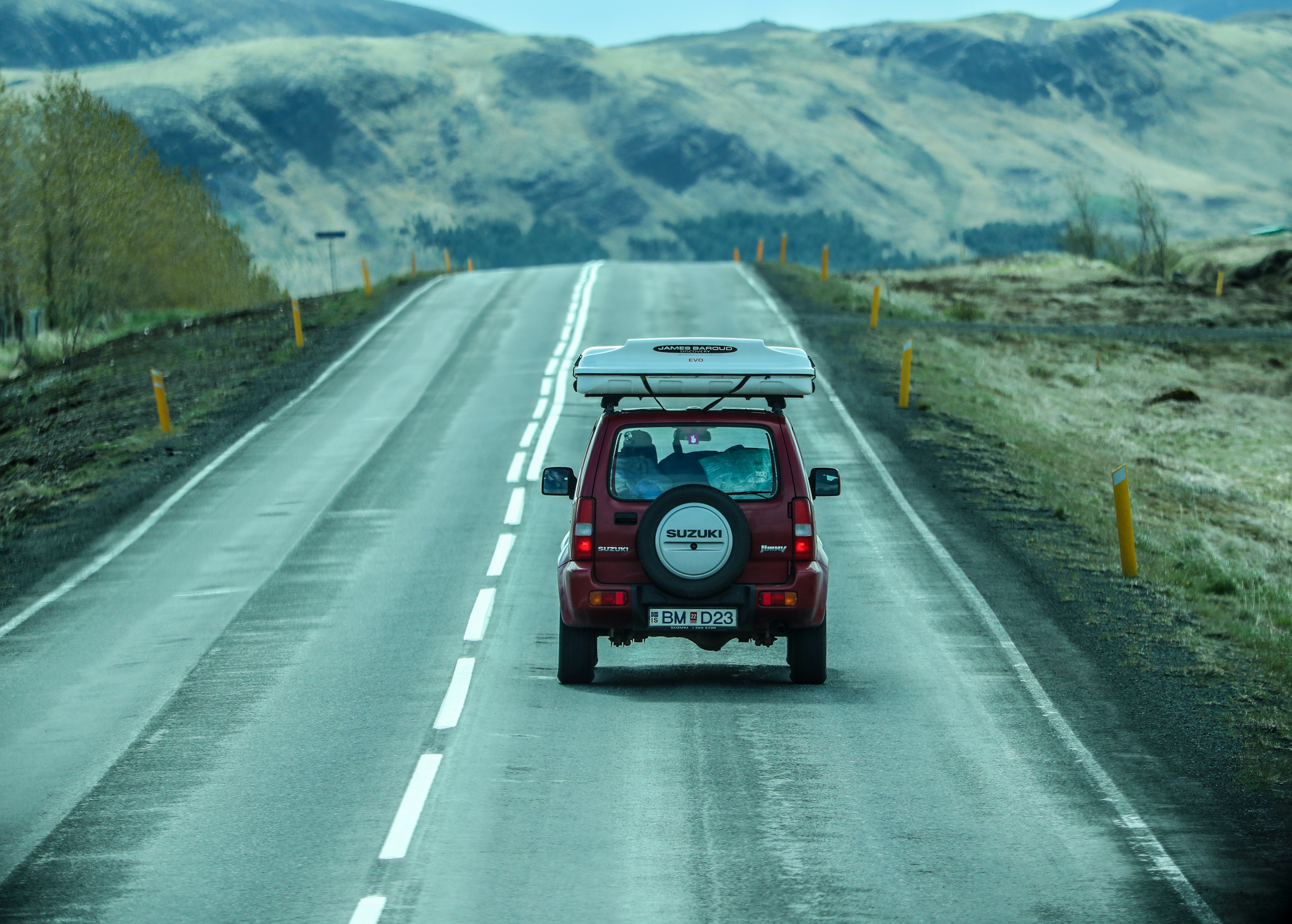 red car on road during daytime