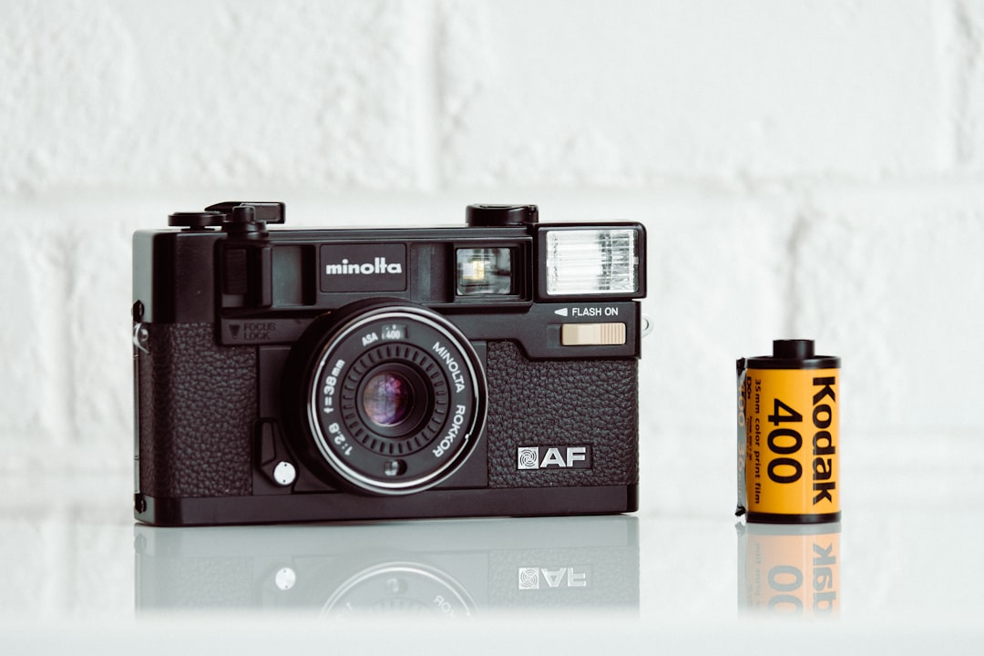 black and silver camera on white table