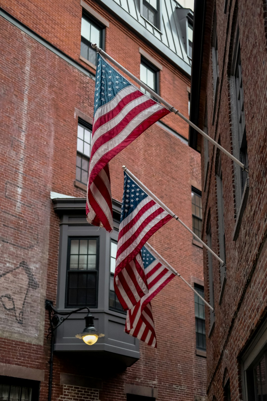 us a flag on brown brick building