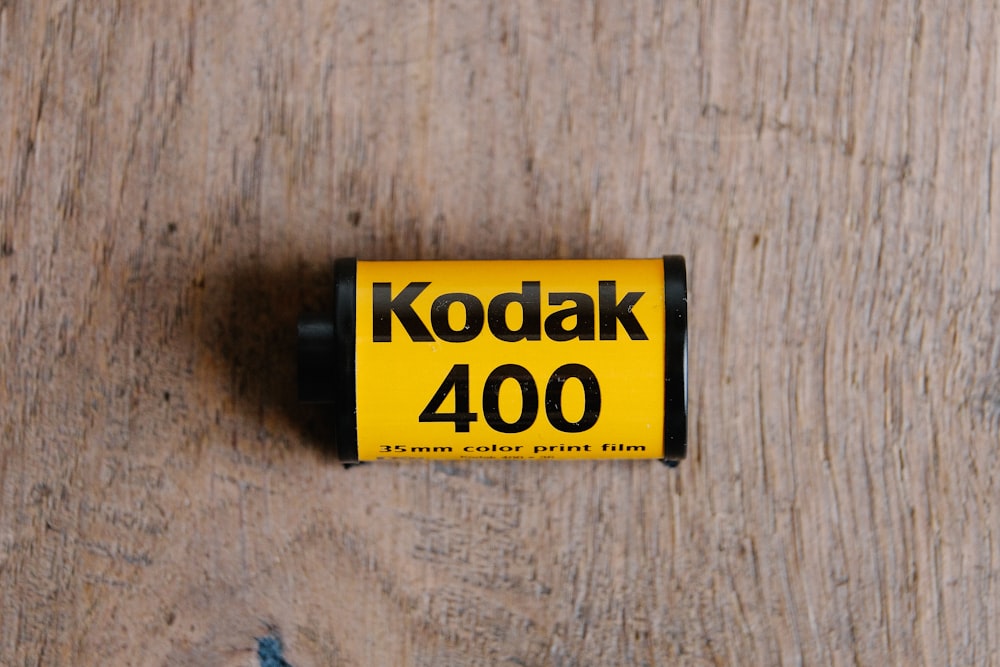 a close up of a battery on a wooden surface