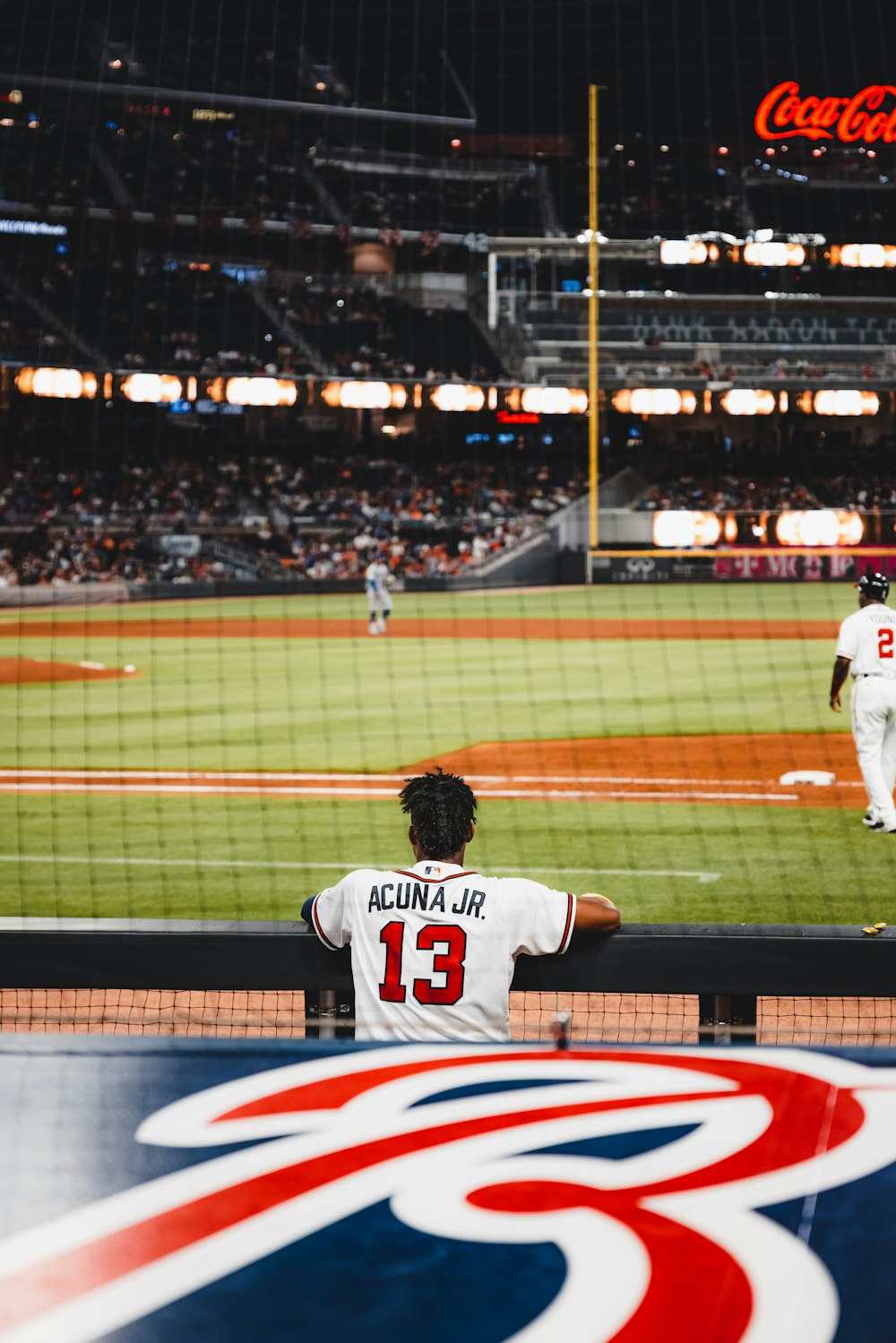 man in white jersey shirt playing baseball