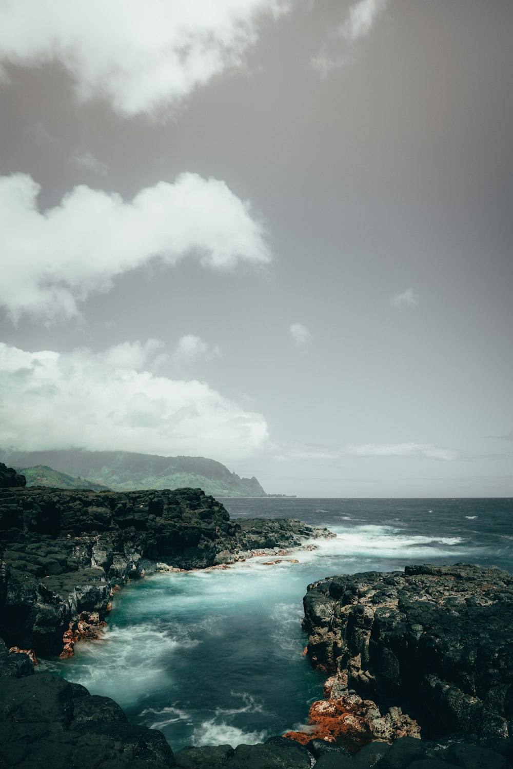 body of water under cloudy sky during daytime