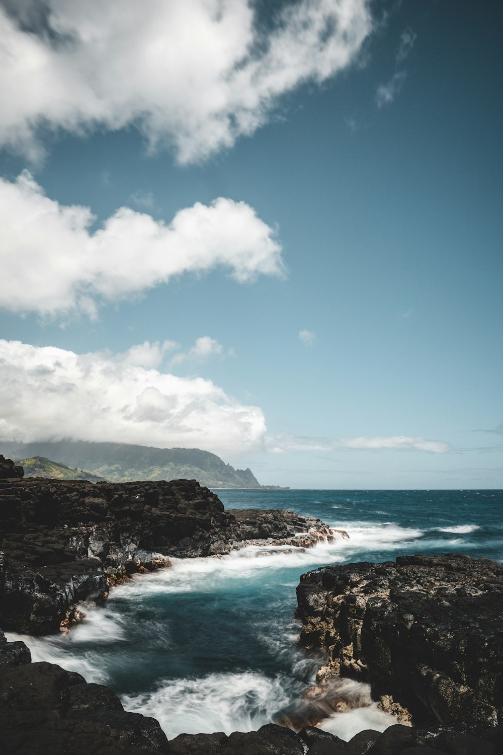 blue sea under blue sky and white clouds during daytime