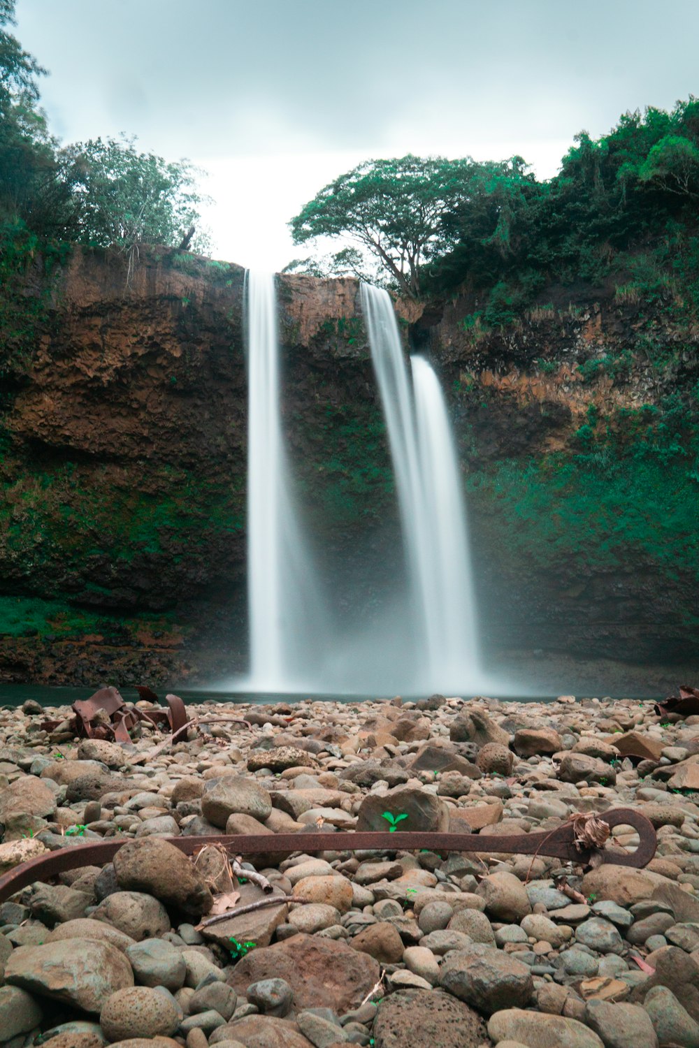 water falls in the middle of the forest