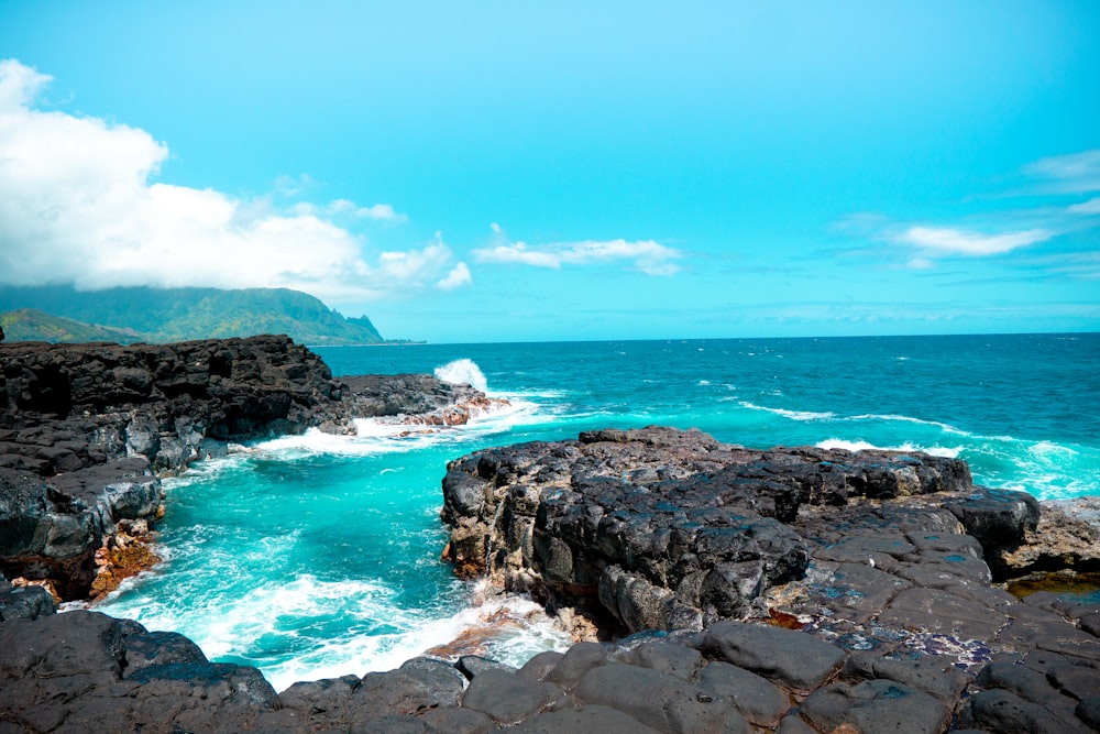 rocky shore under blue sky during daytime