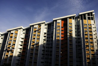 white and red concrete building under blue sky during daytime