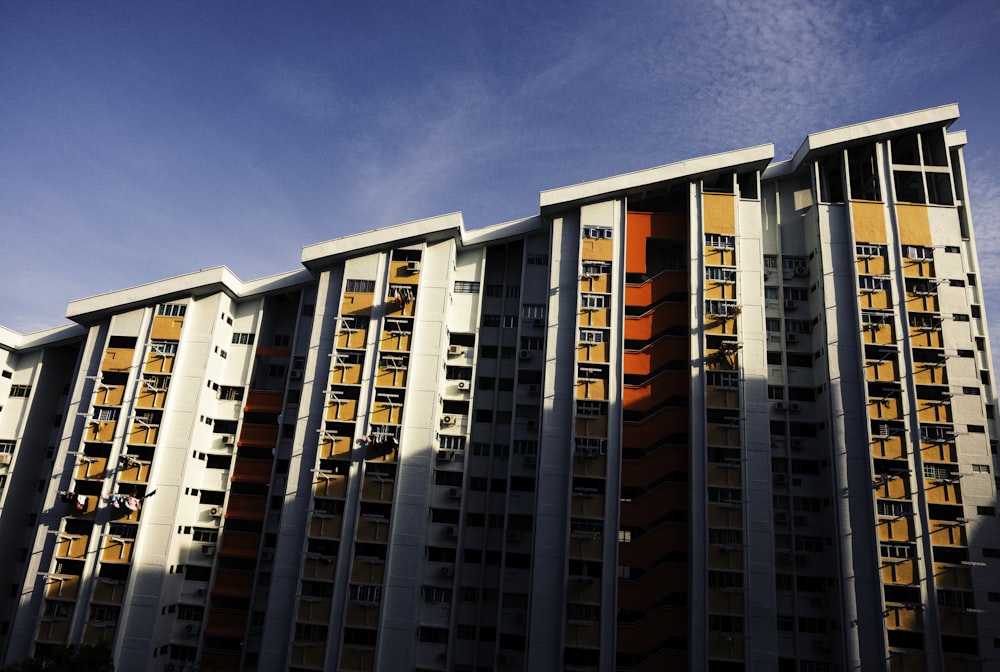 white and red concrete building under blue sky during daytime