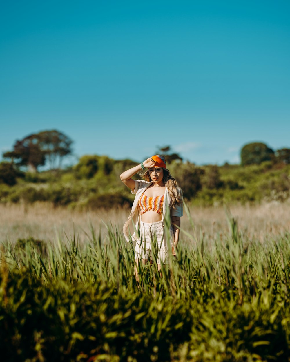 woman in white dress standing on green grass field during daytime