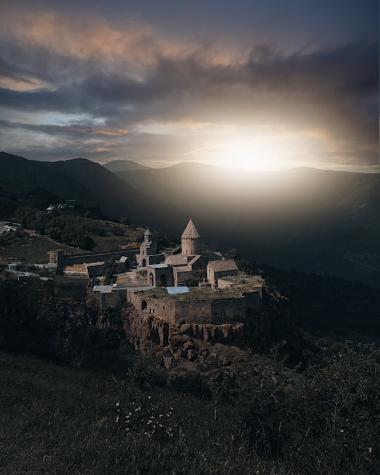 white and brown concrete building on top of mountain during daytime in Tatev Armenia