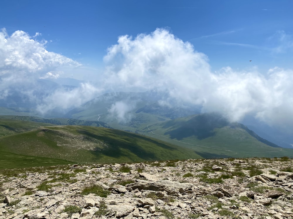 green mountain under white clouds during daytime