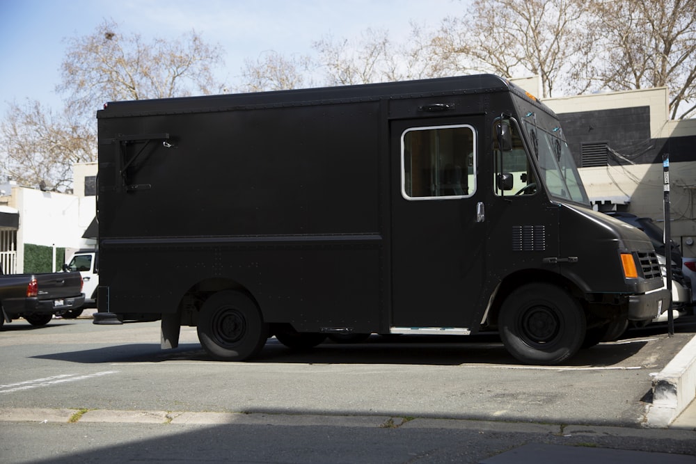 black van on gray asphalt road during daytime