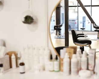 black and silver office rolling chair beside mirror