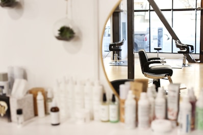black and silver office rolling chair beside mirror