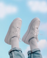 person wearing white nike sneakers