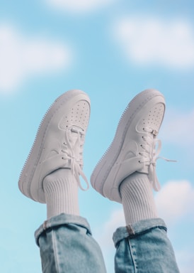 person wearing white nike sneakers