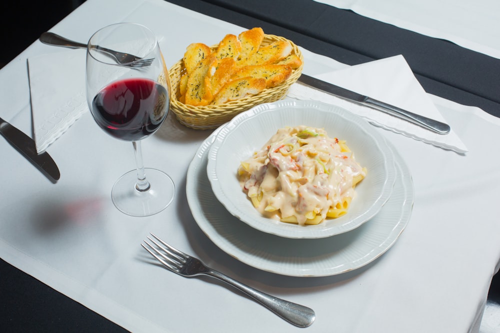 white ceramic plate with stainless steel fork and bread knife