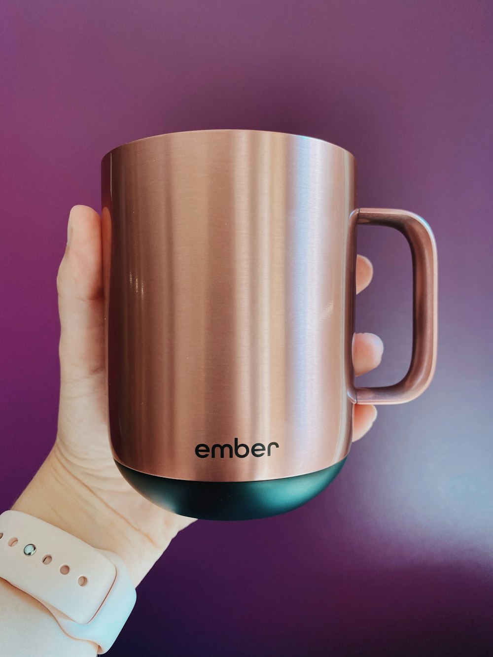 person holding brown and black ceramic mug