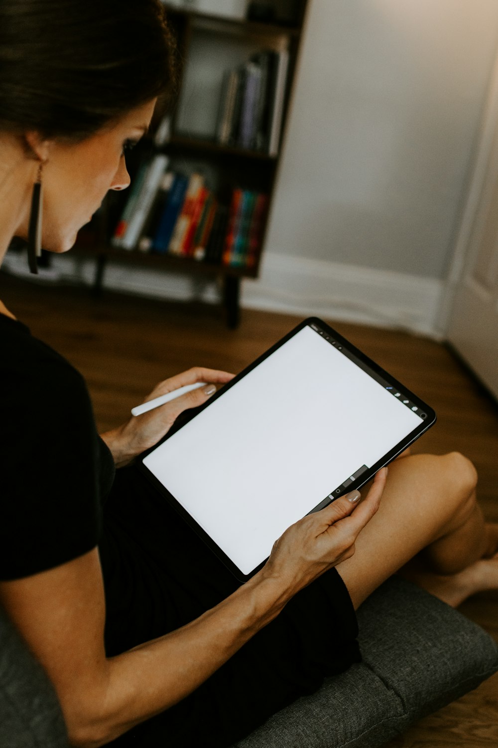 person holding white paper with black pen