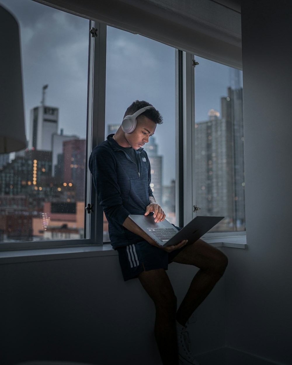 woman in blue denim jacket using laptop computer