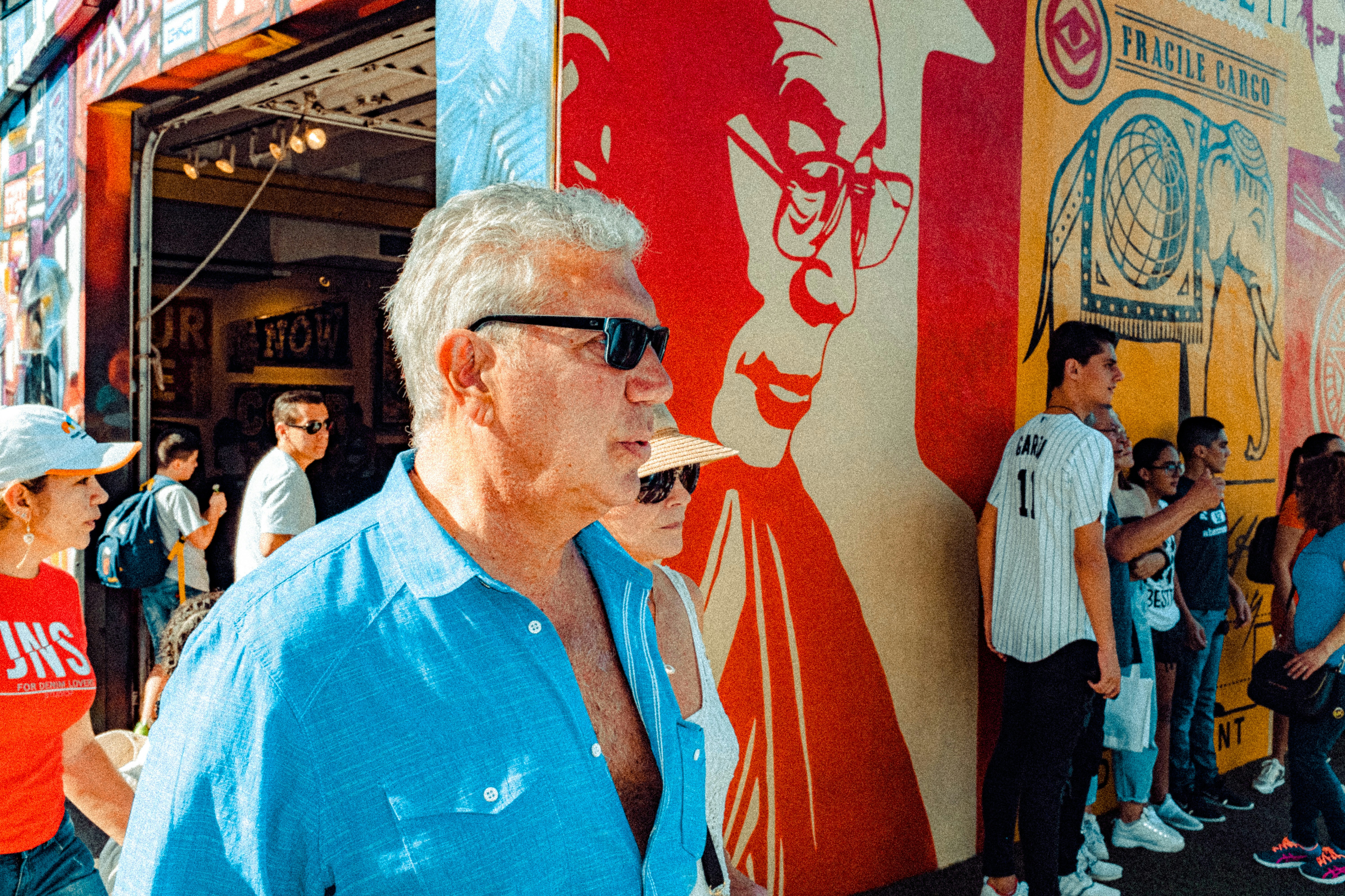 man in blue button up shirt wearing black sunglasses