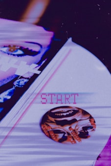 A collage with a retro-futuristic aesthetic features a close-up of an eye partially obscured by abstract white geometric shapes and a glitch effect. Below, the word 'START' is displayed in pixelated pink text on a pale surface. A circular object with a distorted, artistic face image is positioned next to the text.