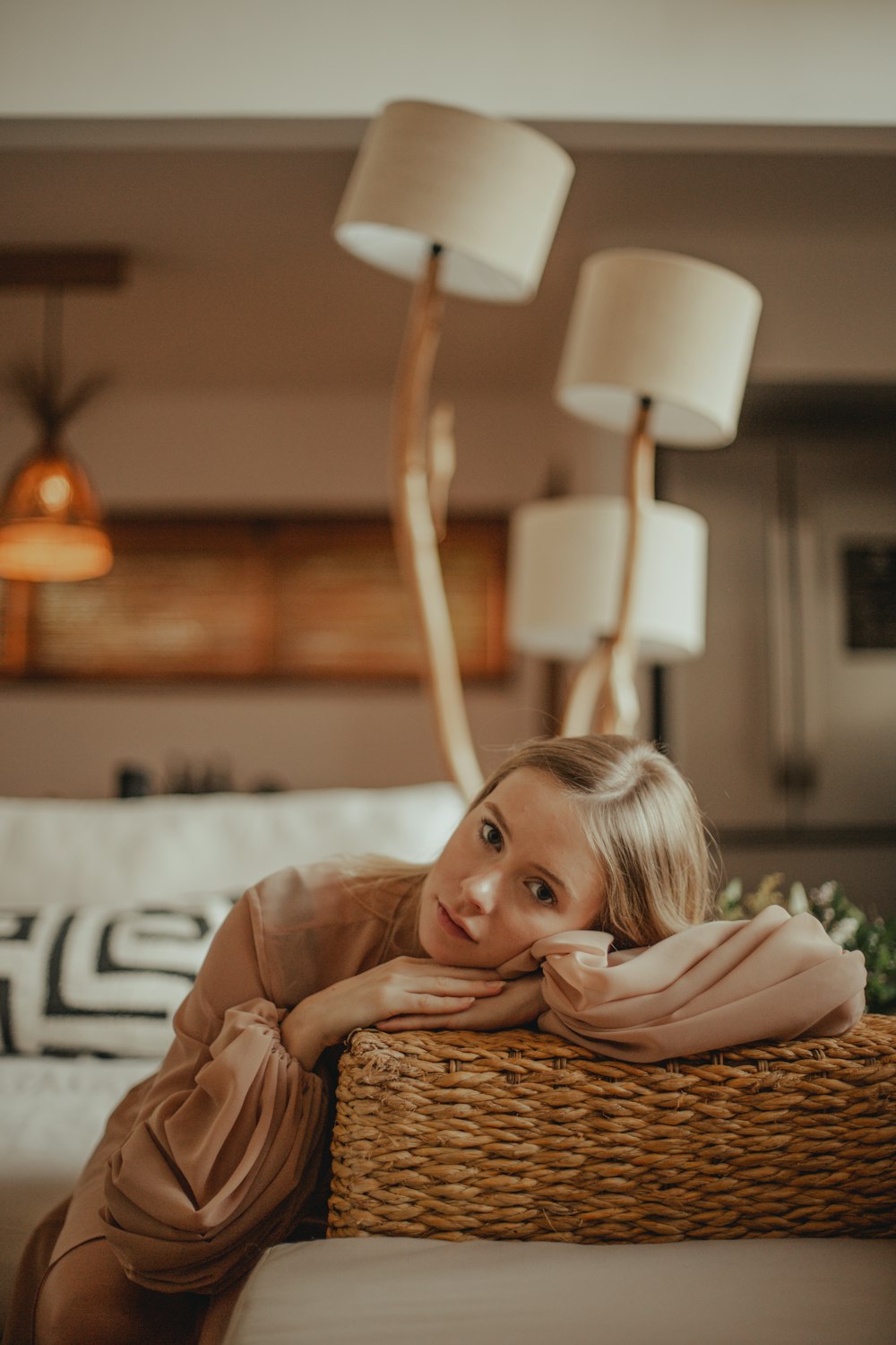 girl in brown long sleeve shirt lying on bed