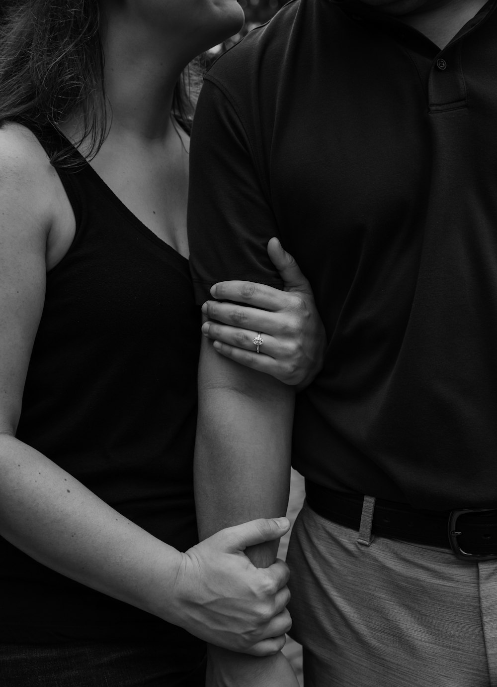 grayscale photo of man and woman holding hands