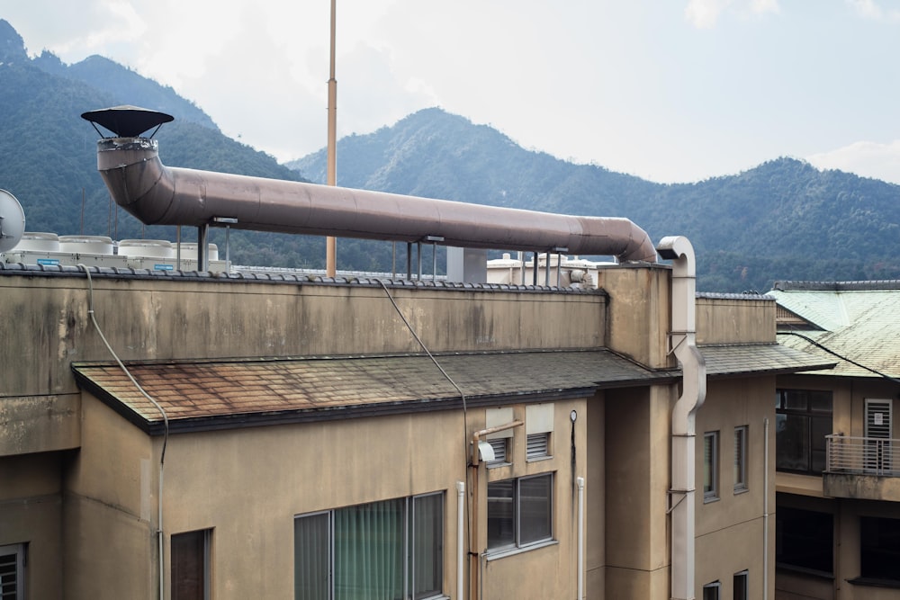 brown concrete building near mountain during daytime