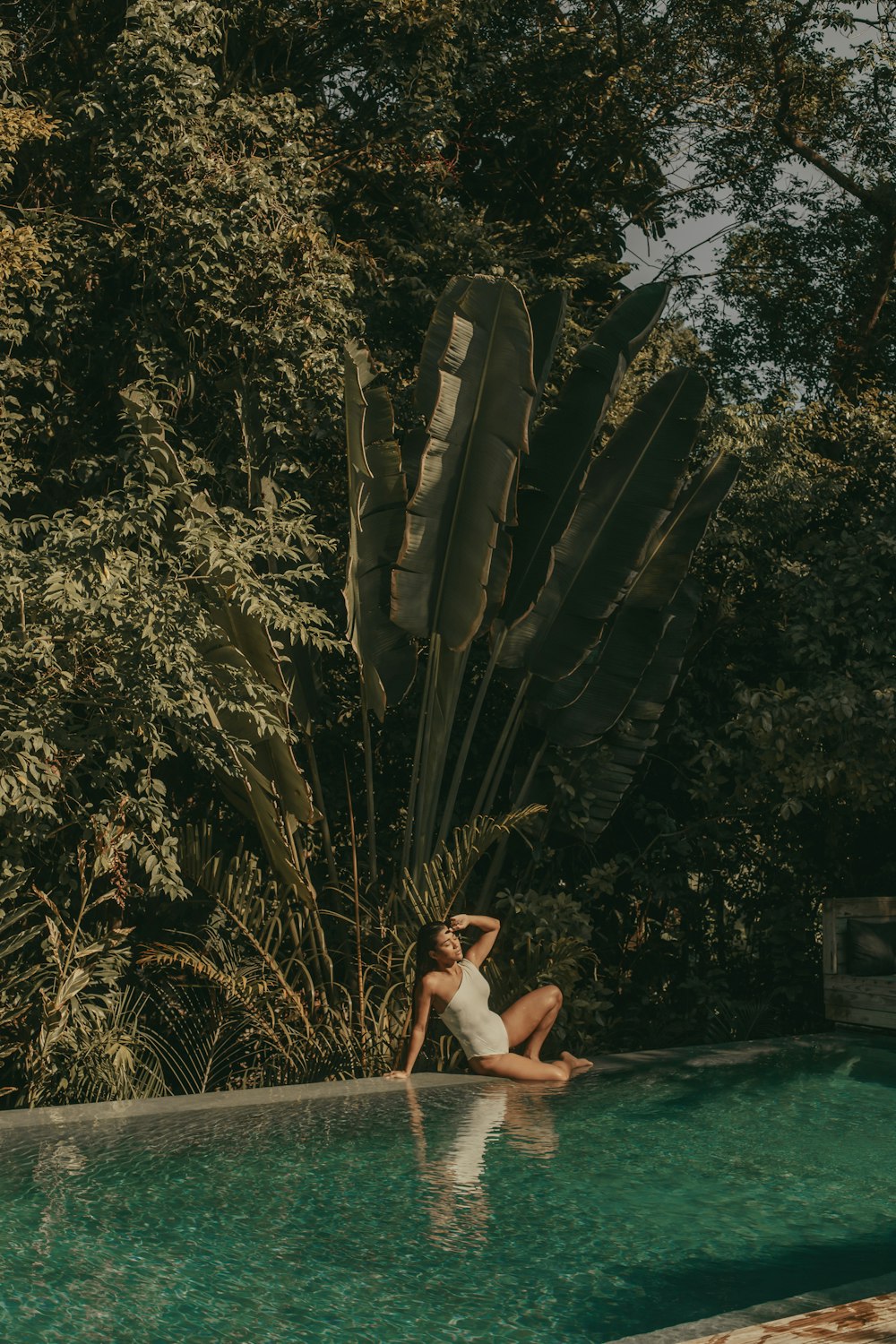 woman in swimming pool during daytime