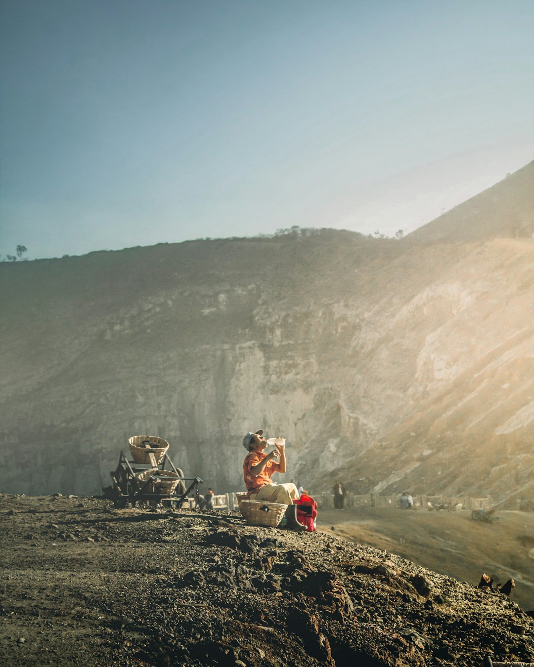 people sitting on rock formation during daytime