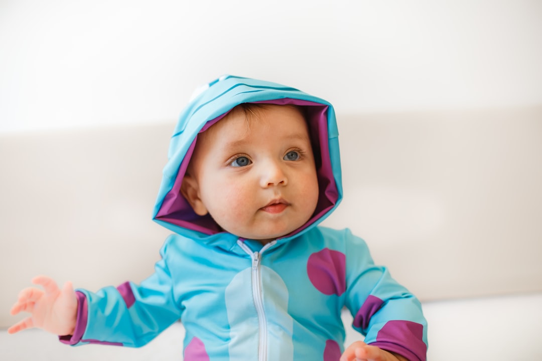baby in blue and white hoodie