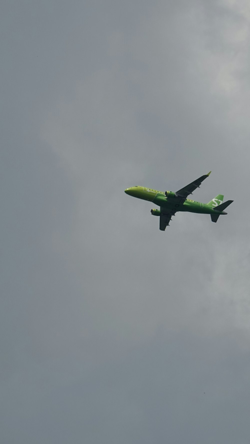 green airplane flying in the sky