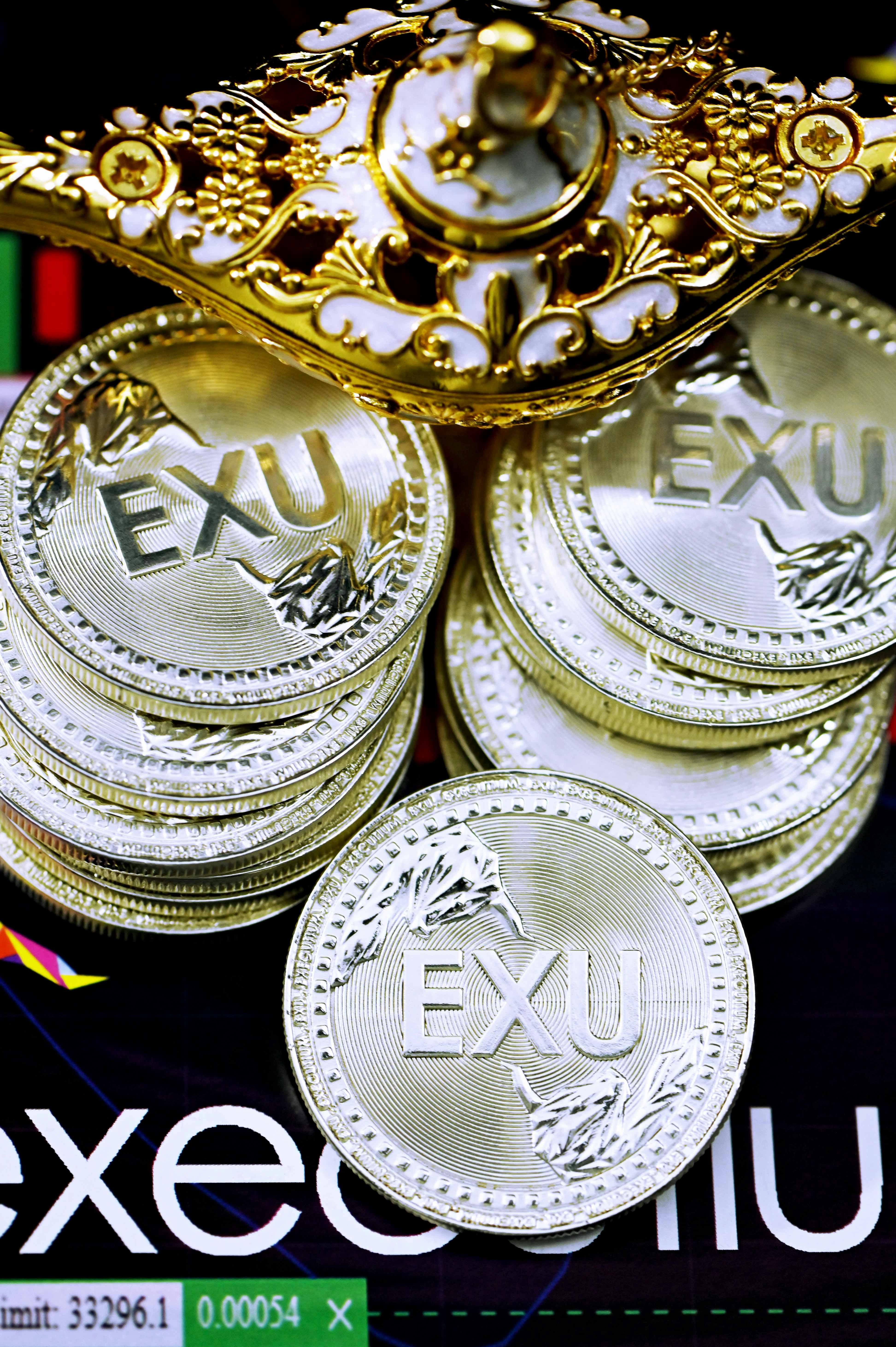 A pile of EXU coins and a magic lamp on top of an Executium background
