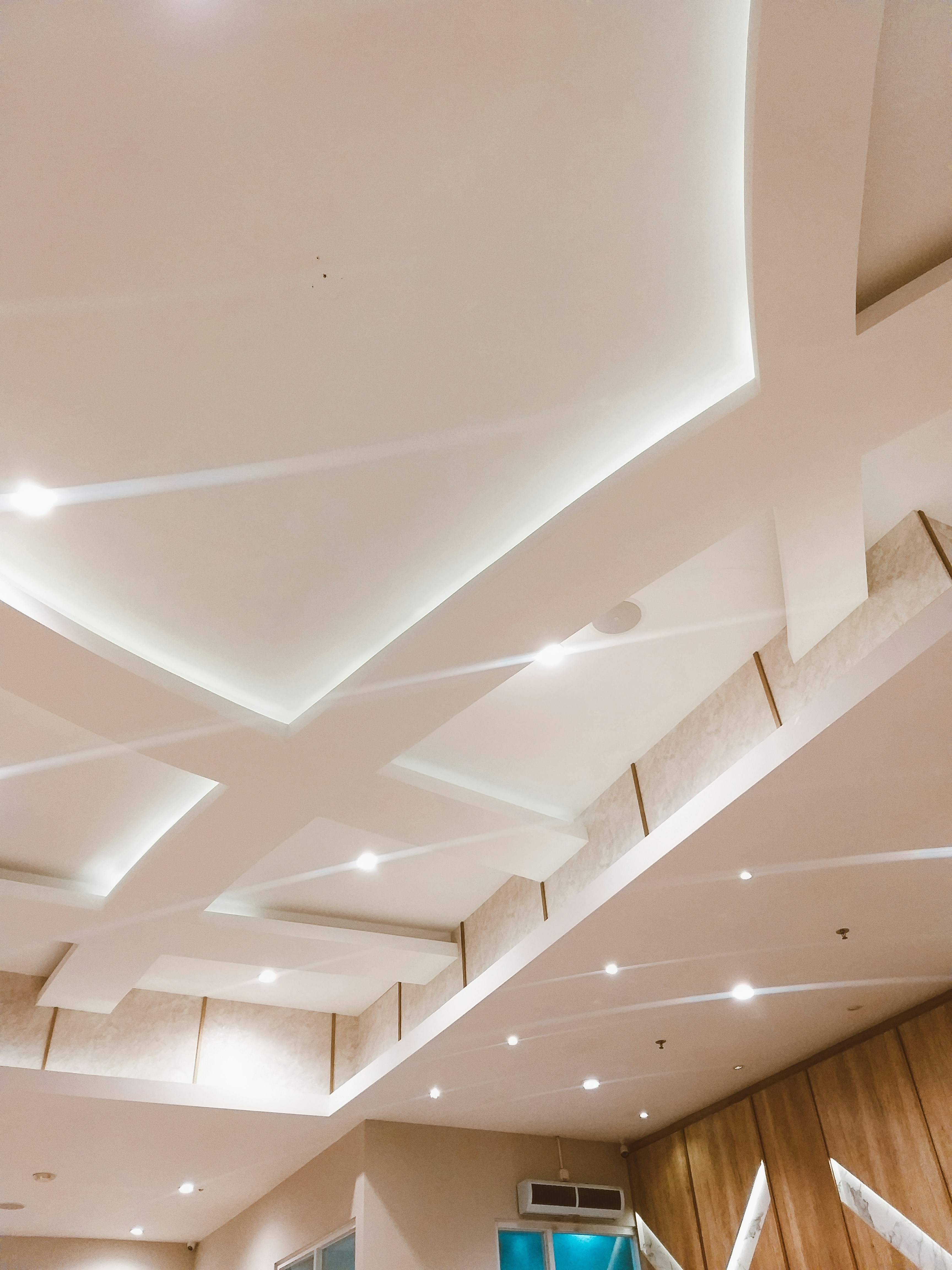 Modern suspended ceiling installation with recessed lighting in residential space