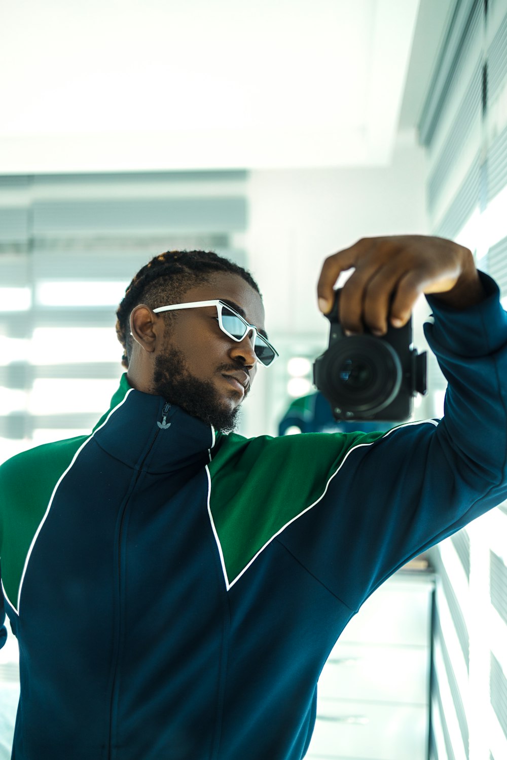 man in blue nike crew neck shirt wearing black sunglasses