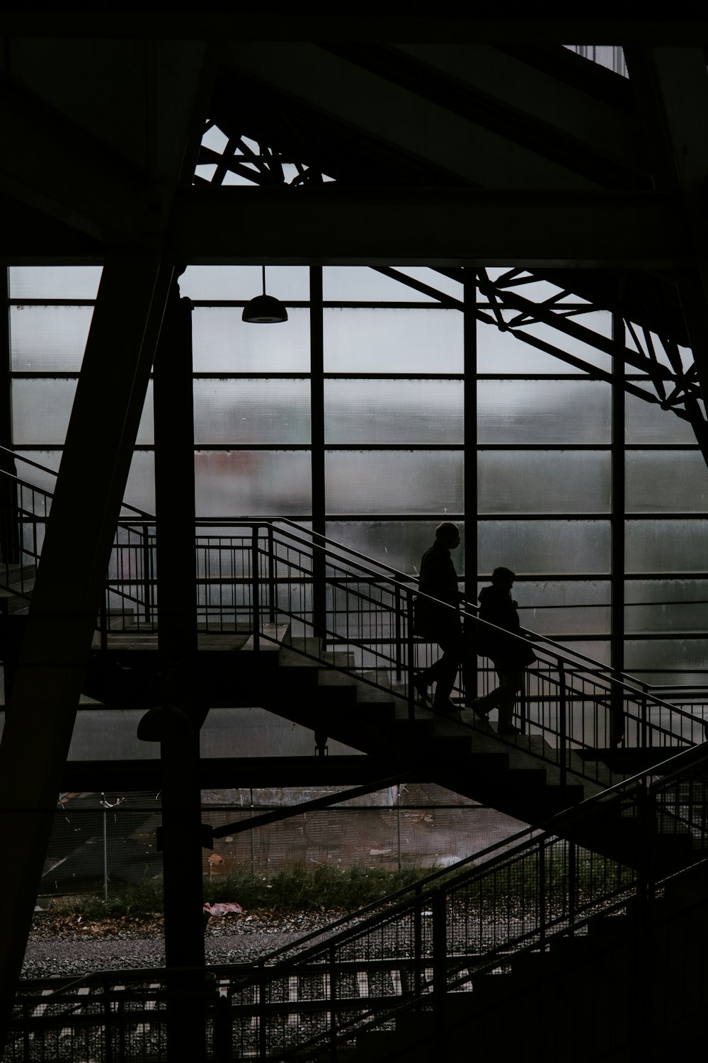 silhouette of 2 people standing on a building