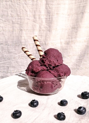 Vibrant mixed berry sorbet served in a glass bowl with fresh berries around.