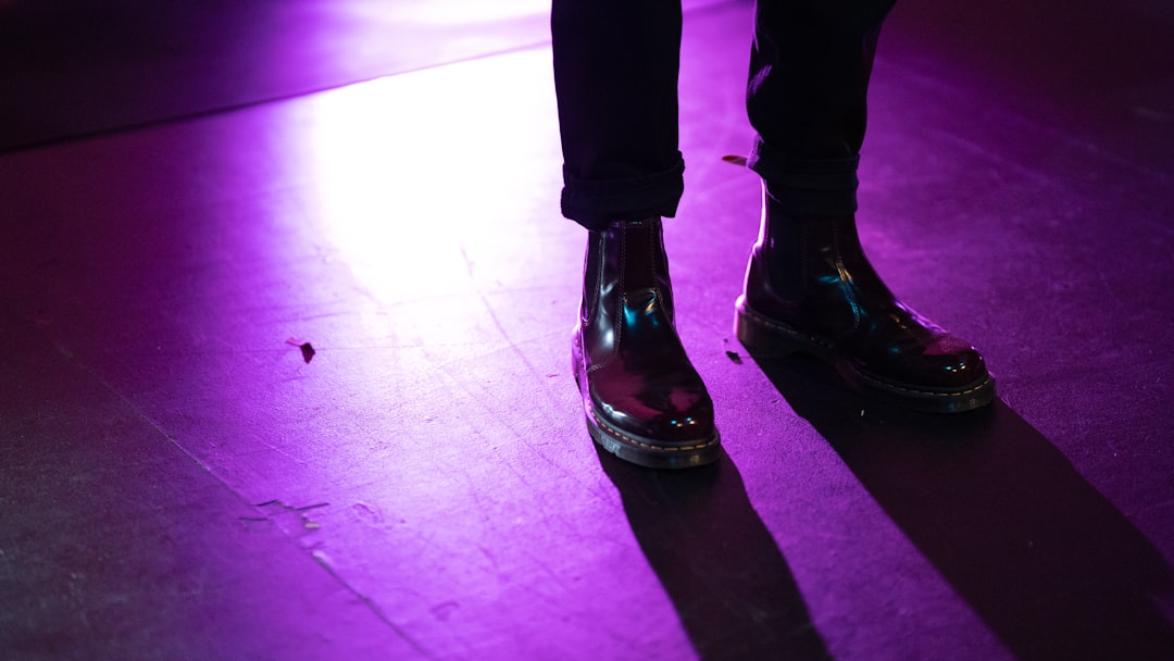 person in black pants and black leather shoes