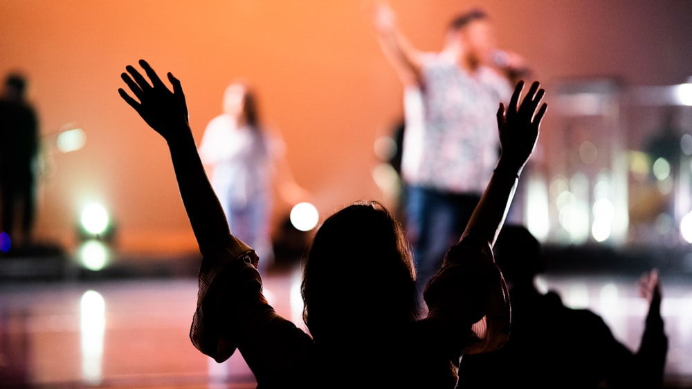 silhouette of man raising his hands