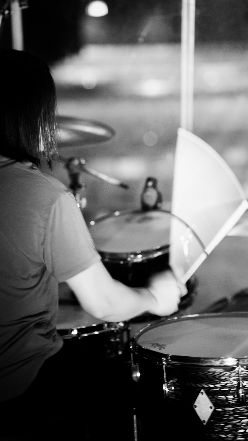 woman playing drum in grayscale photography
