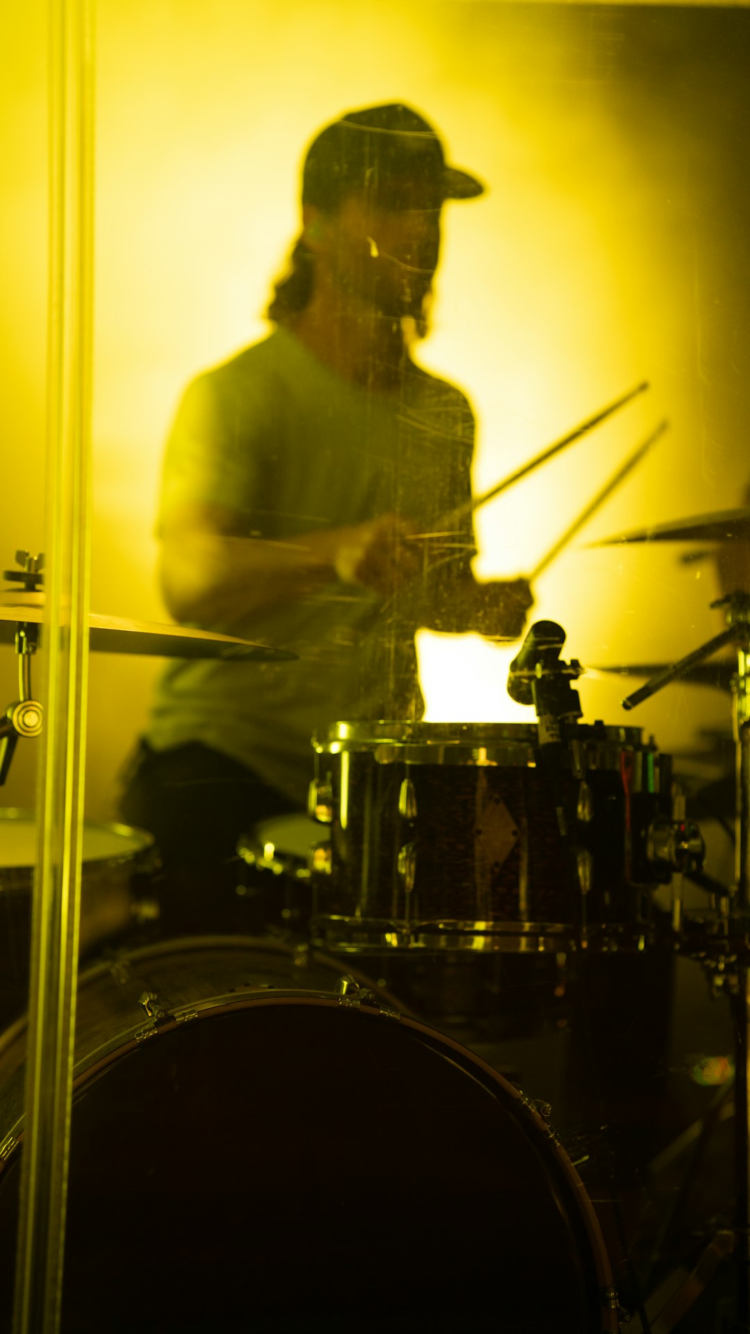man in white dress shirt playing drum set