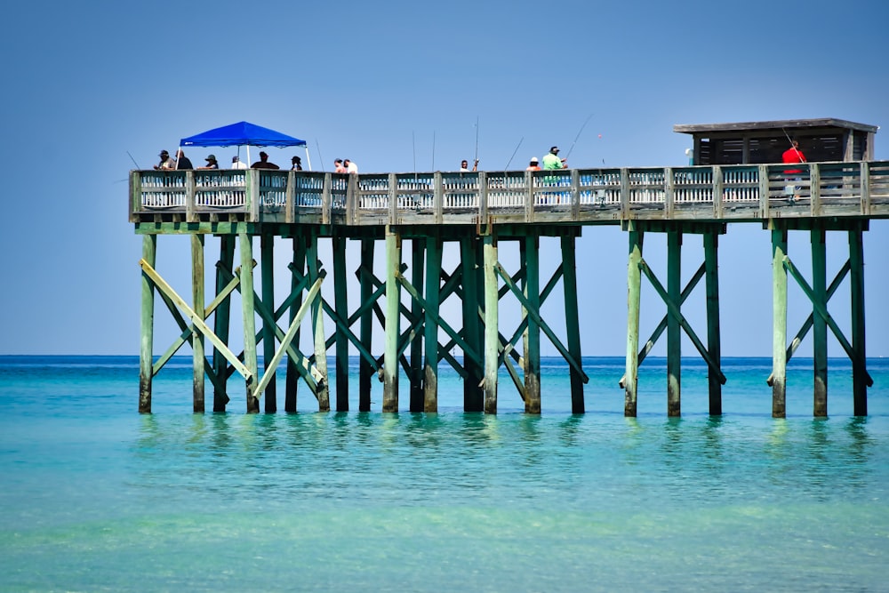 blue umbrella on wooden dock during daytime