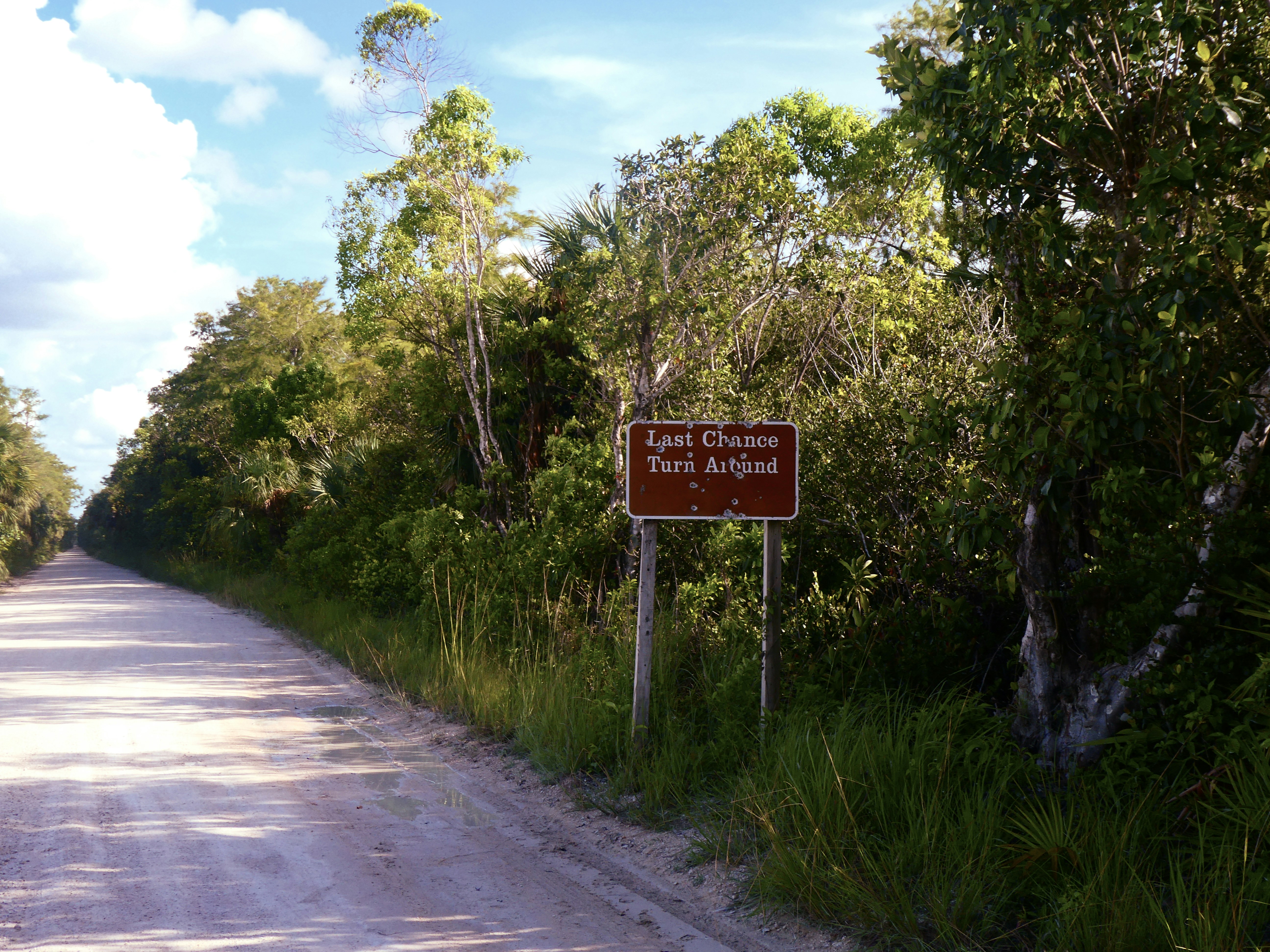 Punta Gorda, Belize (Rio Blanco National Park) - Bullet-holes on a sign on Big Cypress loop trail, Monroe County FL