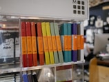 Personalized notebooks with unique covers displayed on a shelf.