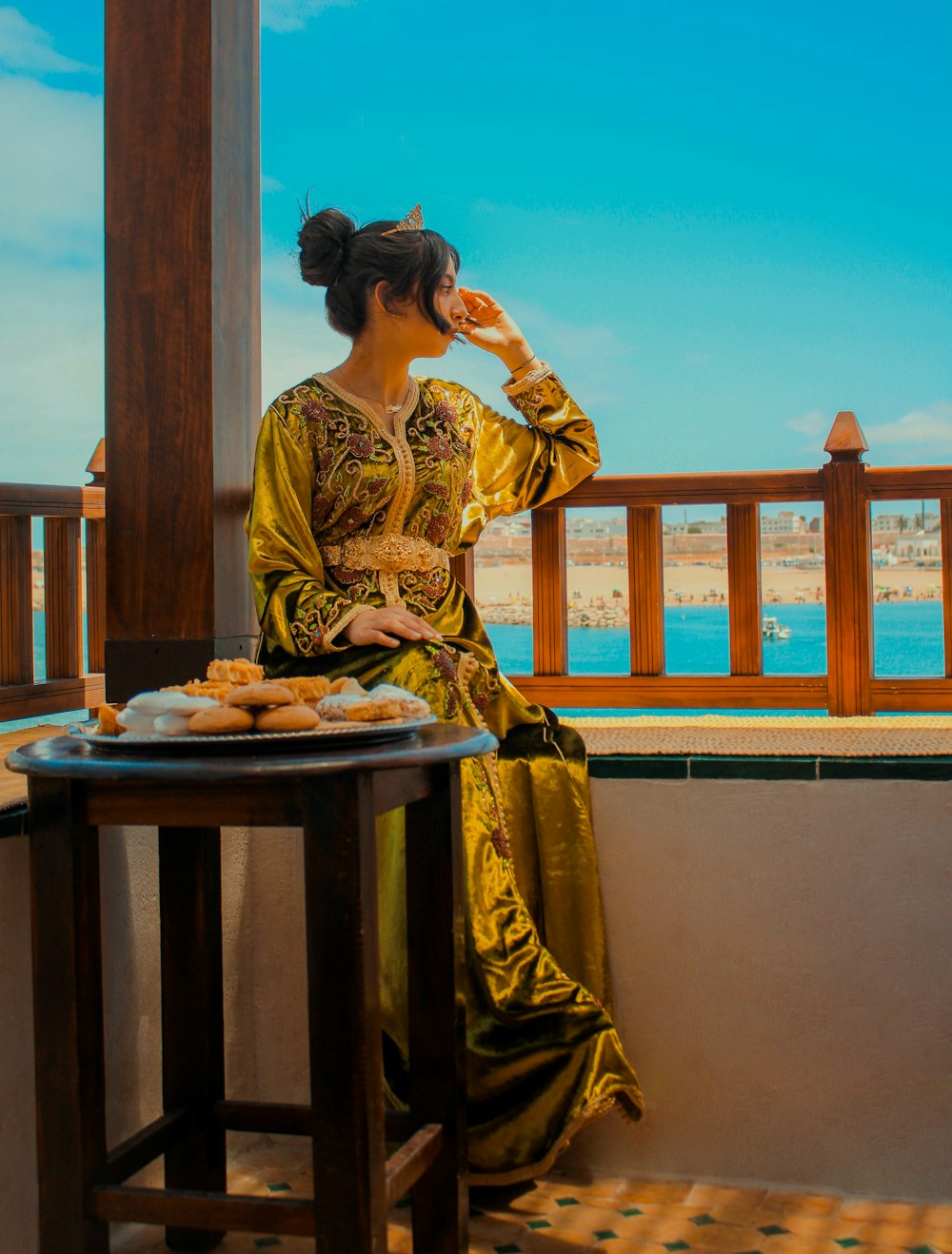 woman in yellow and brown dress sitting on brown wooden chair