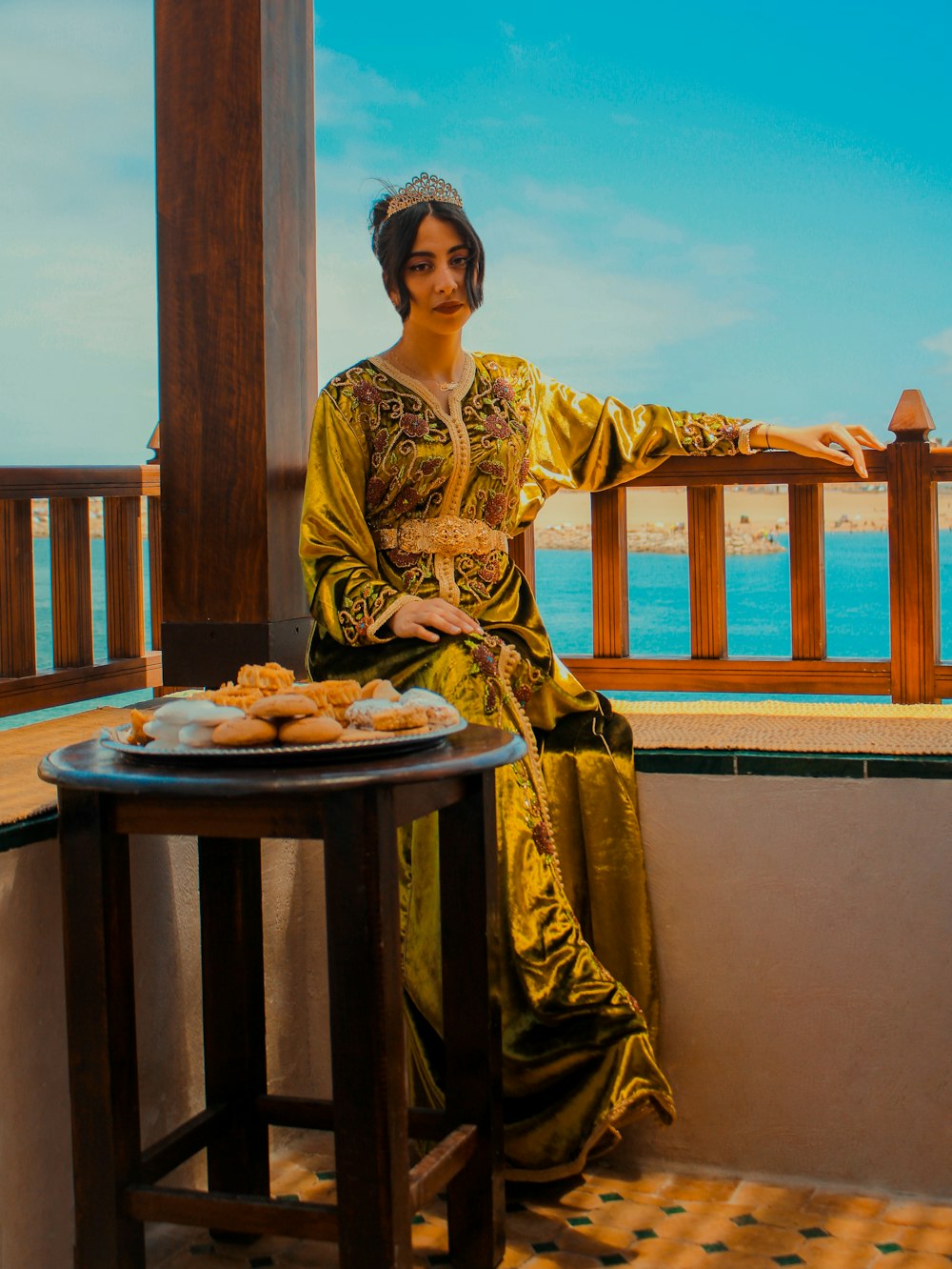 woman in yellow and brown long sleeve dress sitting on brown wooden chair